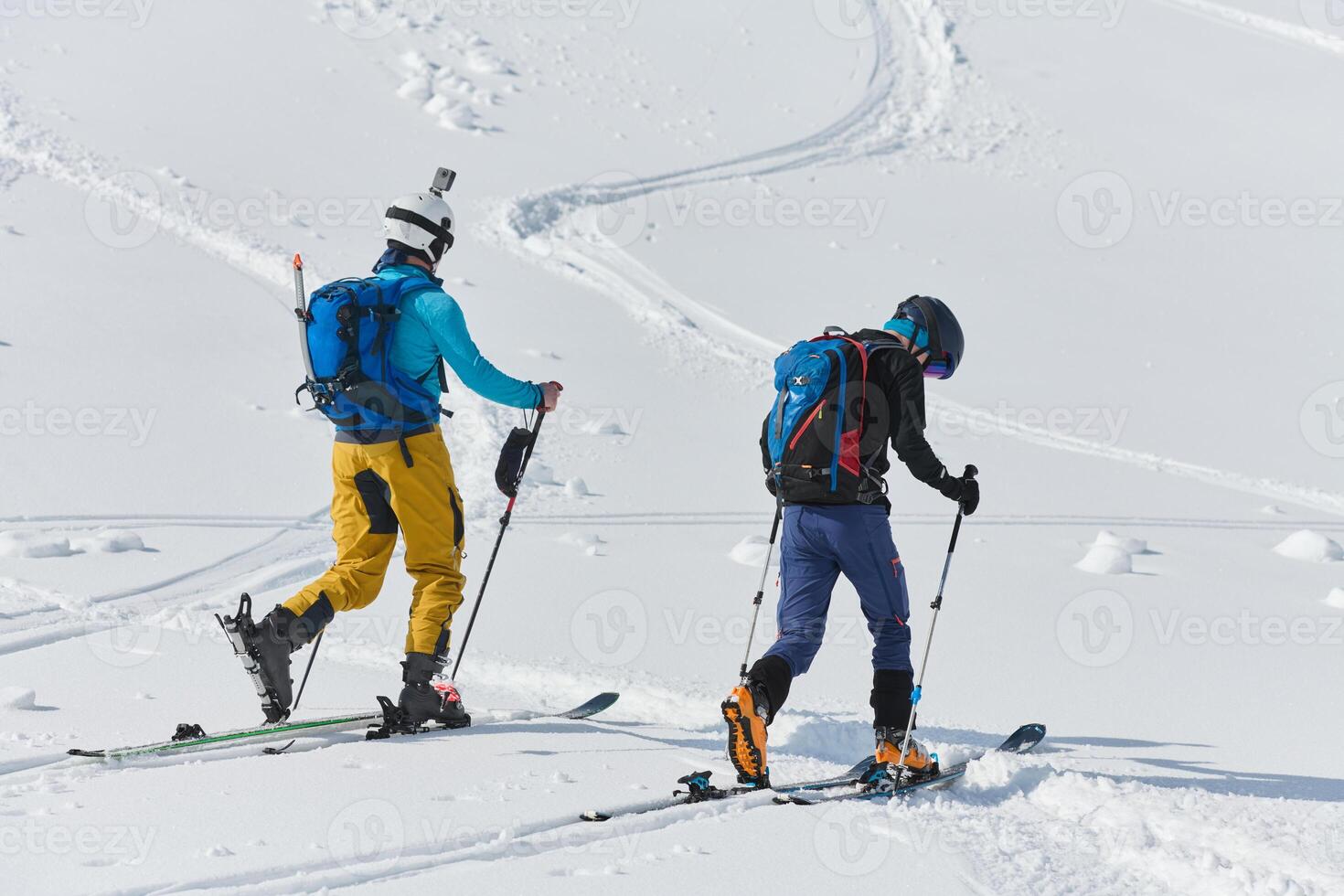 Alpine Ascent. Two Professional Skiers Conquer Snowy Peaks as a Determined Team. photo