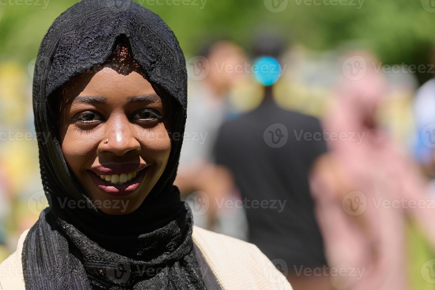 Joyful Middle Eastern Muslim Woman in Hijab Smiling Brightly in a Natural Apiary photo