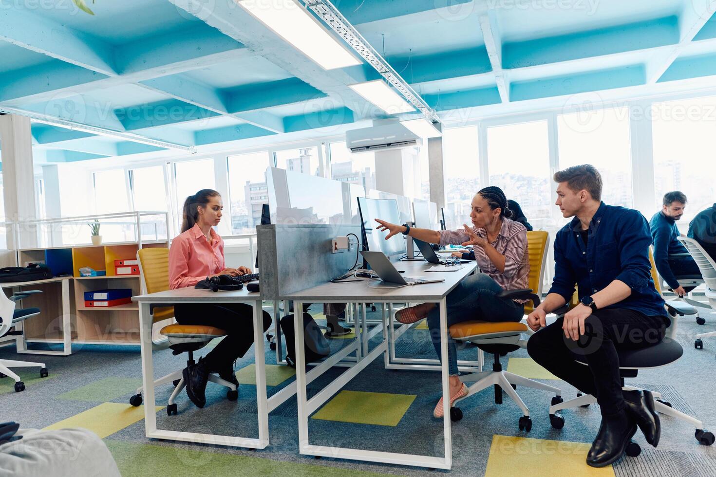 Collaborative process of multicultural skilled young business team during brainstorming meeting in office.Diverse group of young people dressed in formal wear cooperating on developing design project photo