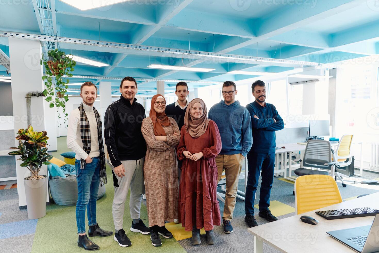 Portrait of a successful creative businessman and businesswoman looking at camera and smiling. Diverse business people standing together at startup. photo
