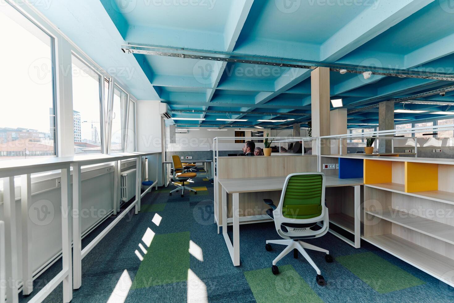 In a modern startup office, a diverse group of young and capable businesspeople engage in lively discussions about various projects, showcasing teamwork, innovation, and entrepreneurial spirit photo