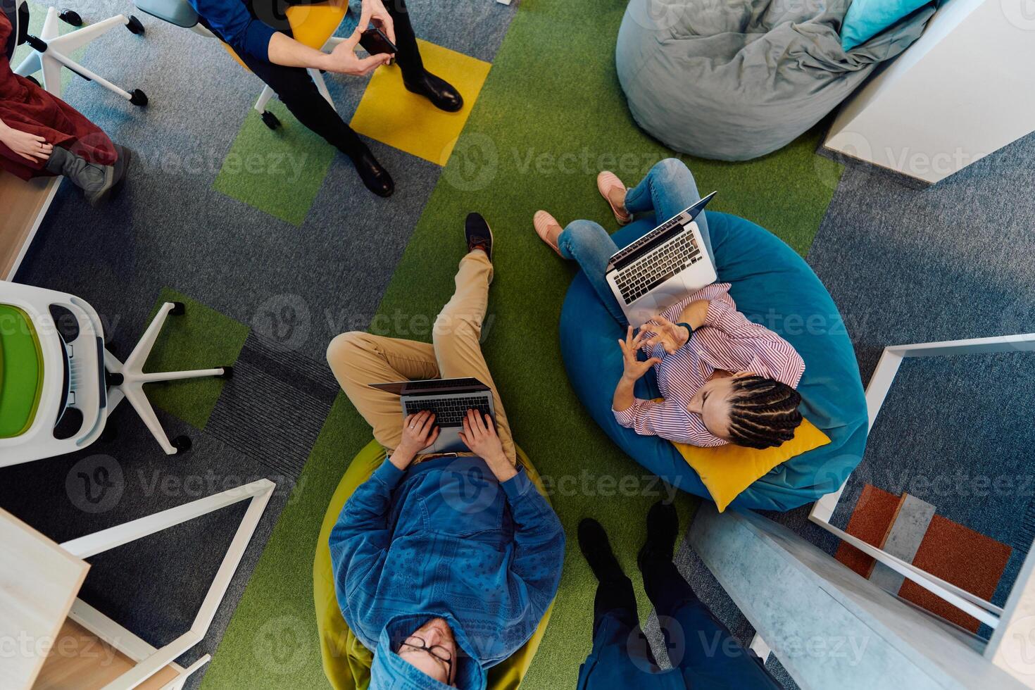 Top view photo of collaborative process of multicultural skilled young business team during brainstorming meeting in office.Diverse group of young people dressed in formal wear cooperating on