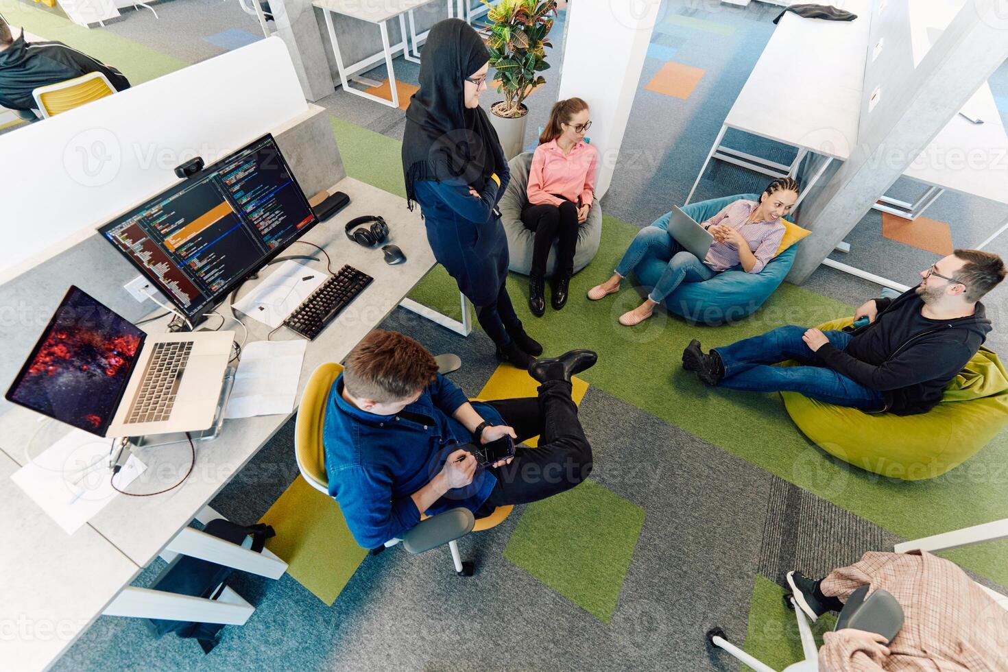 Top view photo of collaborative process of multicultural skilled young business team during brainstorming meeting in office.Diverse group of young people dressed in formal wear cooperating on
