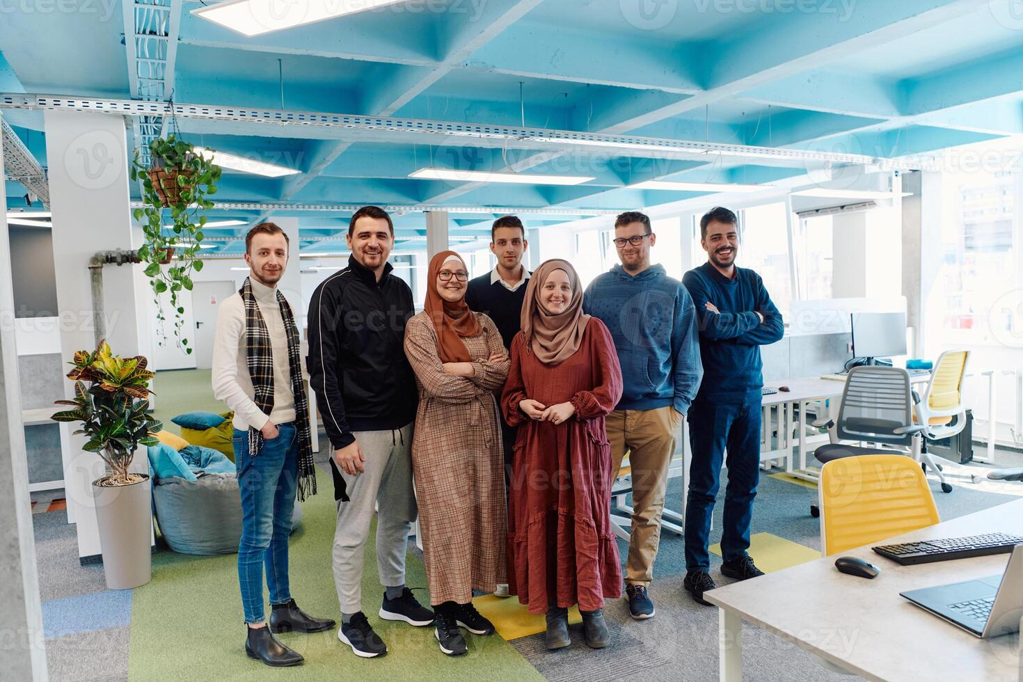 Portrait of a successful creative businessman and businesswoman looking at camera and smiling. Diverse business people standing together at startup. photo