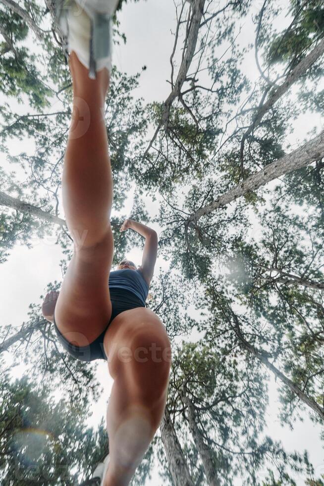 Adventurous Woman Overcoming Forest Obstacles with Determination and Agility. photo