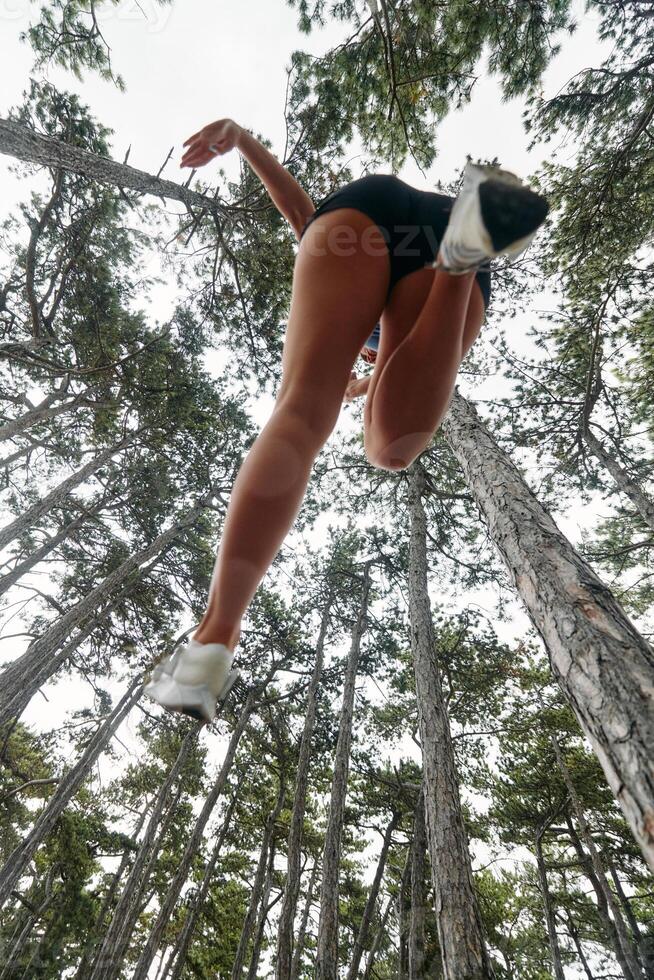 Adventurous Woman Overcoming Forest Obstacles with Determination and Agility. photo