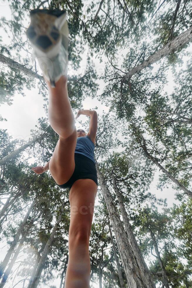 Adventurous Woman Overcoming Forest Obstacles with Determination and Agility. photo