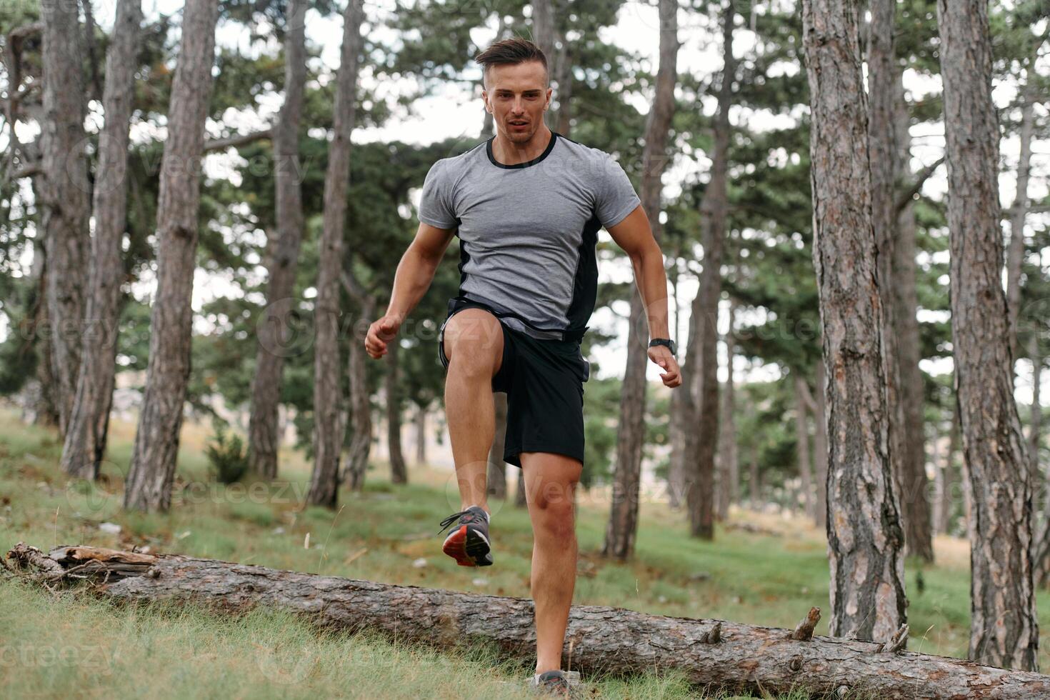 Determined Man Conquering Forest Obstacles with Grit and Speed photo
