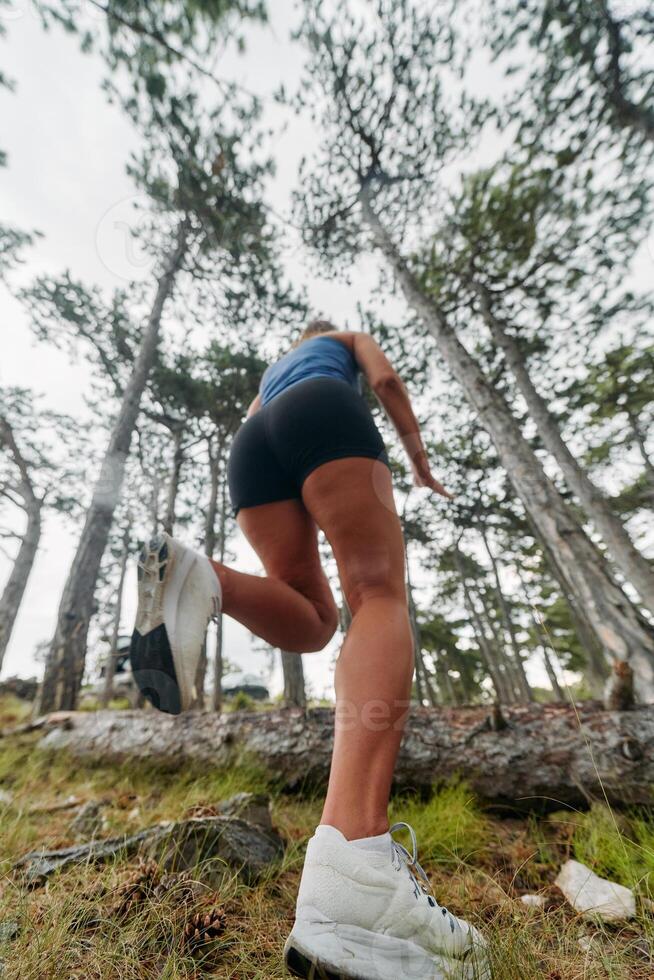 Adventurous Woman Overcoming Forest Obstacles with Determination and Agility. photo