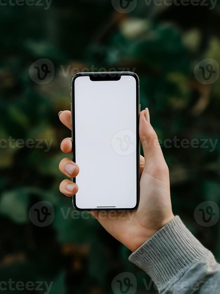 a hand holding an iphone x mockup photo