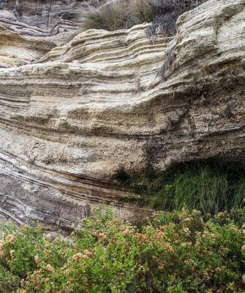 Piled up geological rock formations on the beach of Tenerife. photo