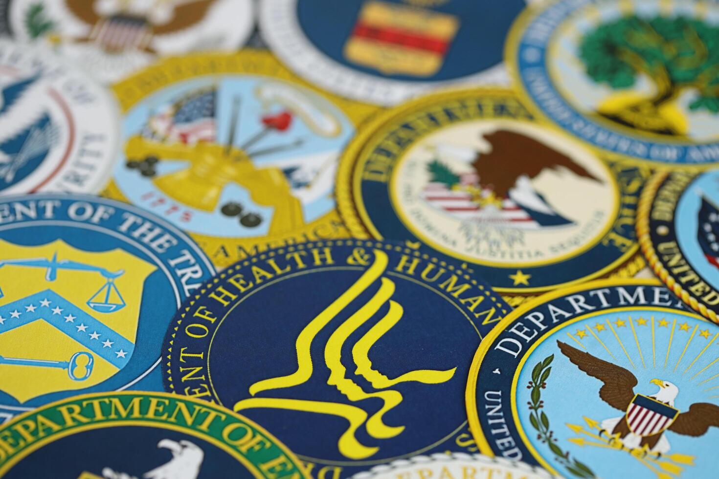 KYIV, UKRAINE - MARCH 9, 2024 Seals of United States of America Departments printed on paper photo