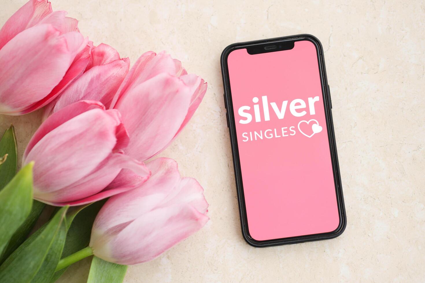KYIV, UKRAINE - FEBRUARY 23, 2024 Silver Singles logo of famous dating website or app on iPhone display photo