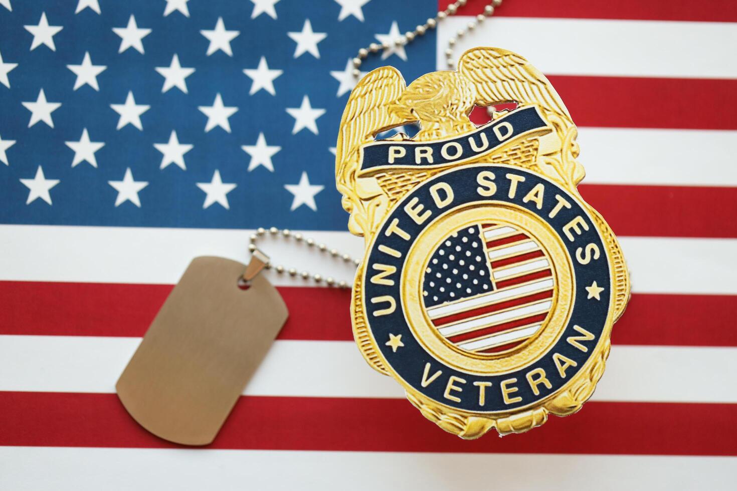 KYIV, UKRAINE - MARCH 9, 2024 US Proud Veteran badge with dogtags on United States of America flag photo
