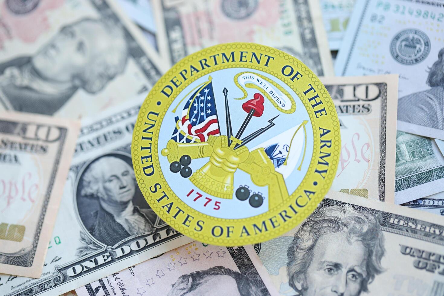 KYIV, UKRAINE - MARCH 9, 2024 US Department of Army seal on many US dollar bills photo