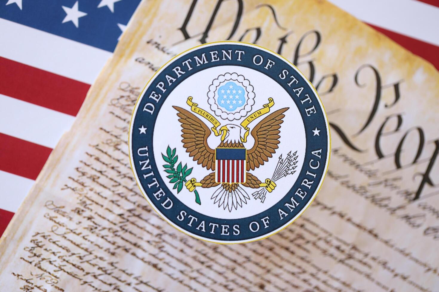 KYIV, UKRAINE - MARCH 9, 2024 US Department of State seal with United States Constitution on flag photo