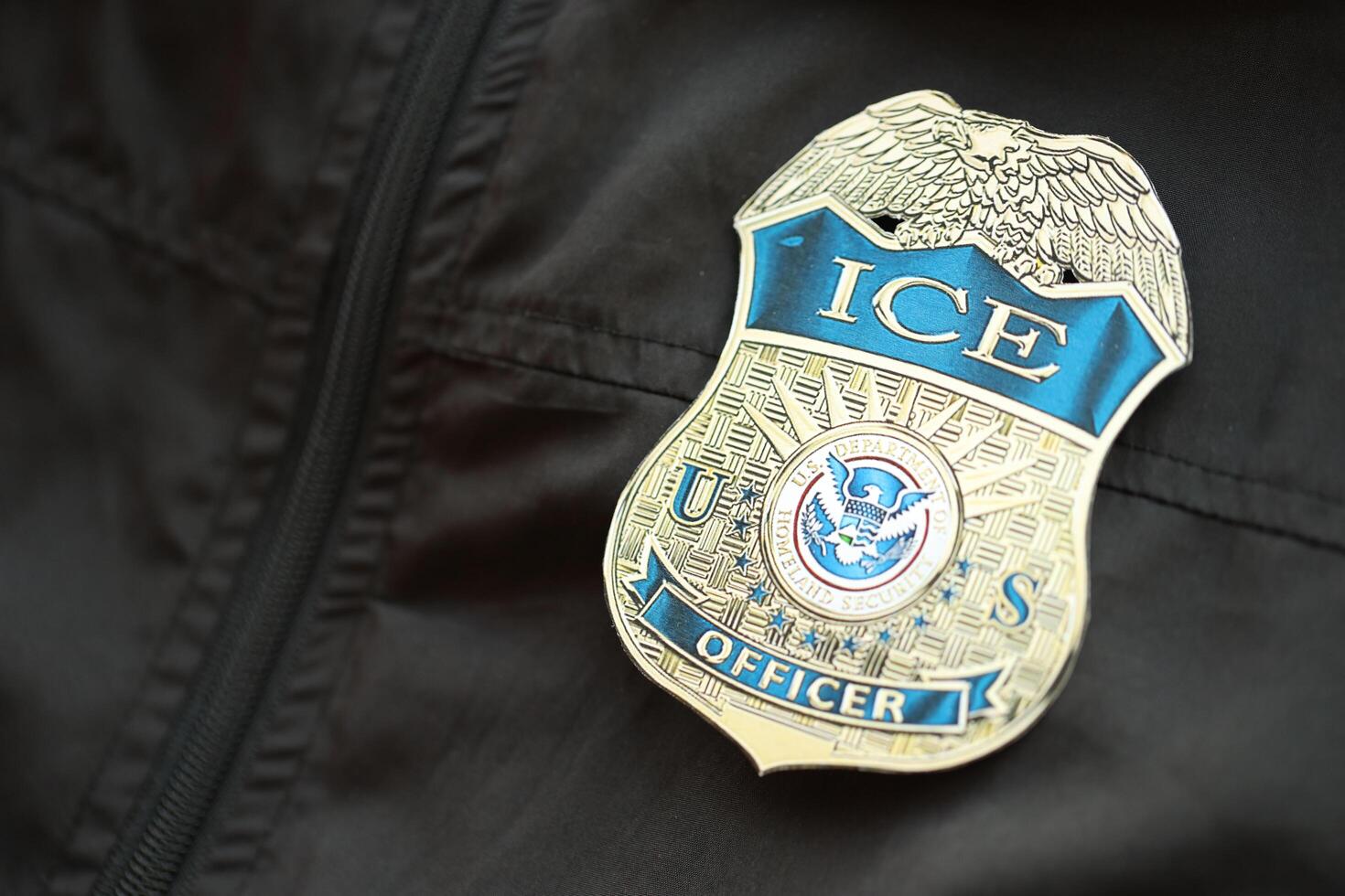 KYIV, UKRAINE - MARCH 9, 2024 US ICE Officer badge on black jacket uniform photo