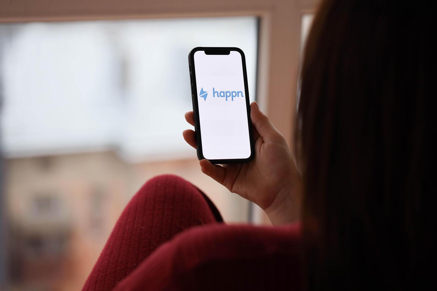 KYIV, UKRAINE - FEBRUARY 23, 2024 Happn logo of famous dating website or app on iPhone display photo