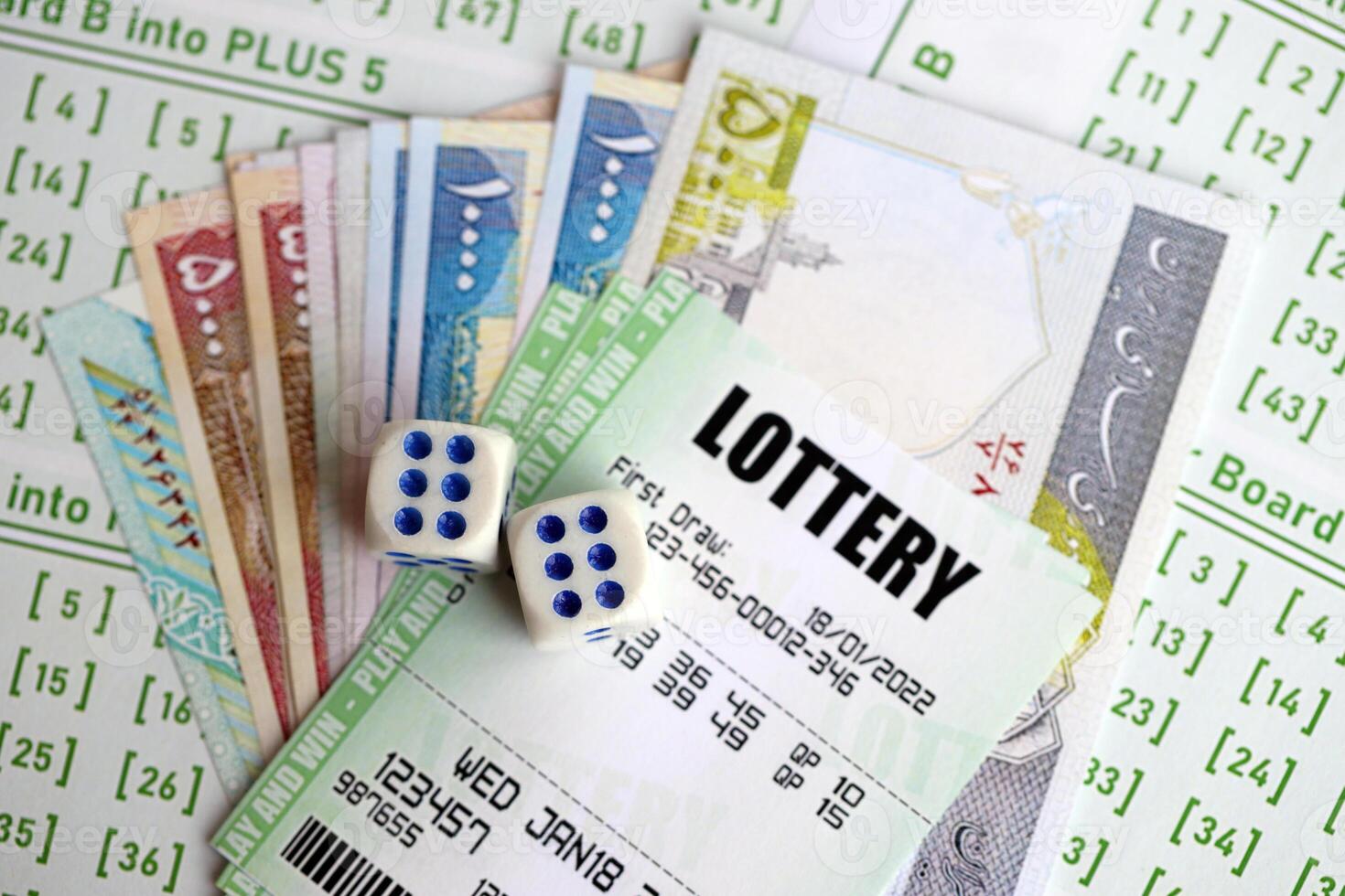 Green lottery tickets and iranian money bills on blank with numbers for playing lottery photo
