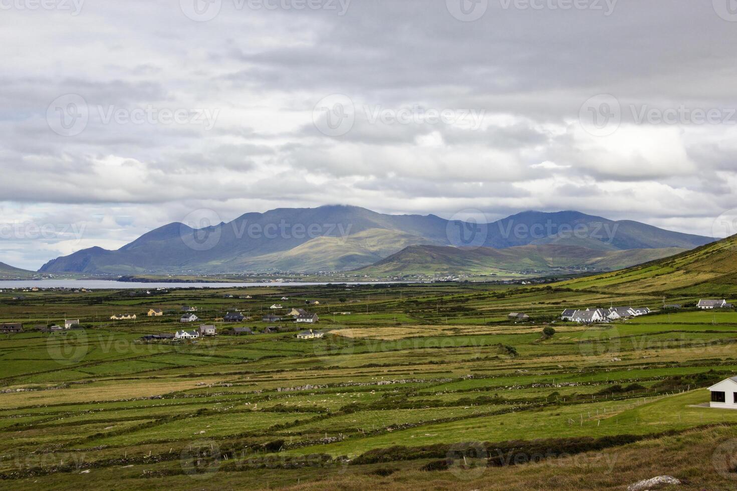 Rolling Green Hills And Distant Mountains In County Kerry, Ireland photo