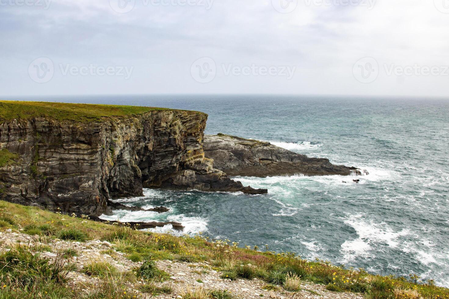 Dramatic Cliffs and Crashing Waves Along the Irish Coastline photo