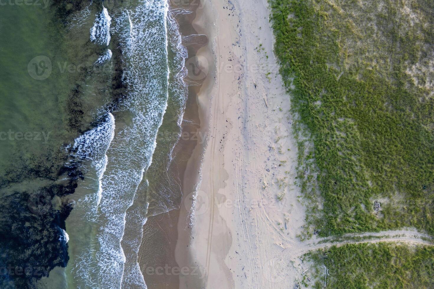 Aerial View of Coastal Shoreline With Waves, Sand, and Grass, on the Magdalen Islands, Quebec, Canada photo