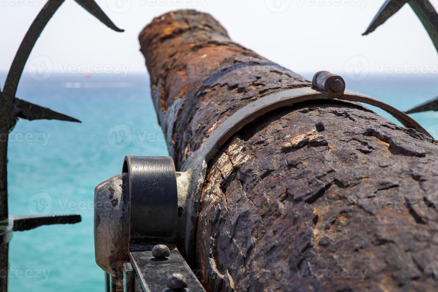 Closeup of a Rusty Cannon Barrel Pointing Towards the Ocean, in Spain photo