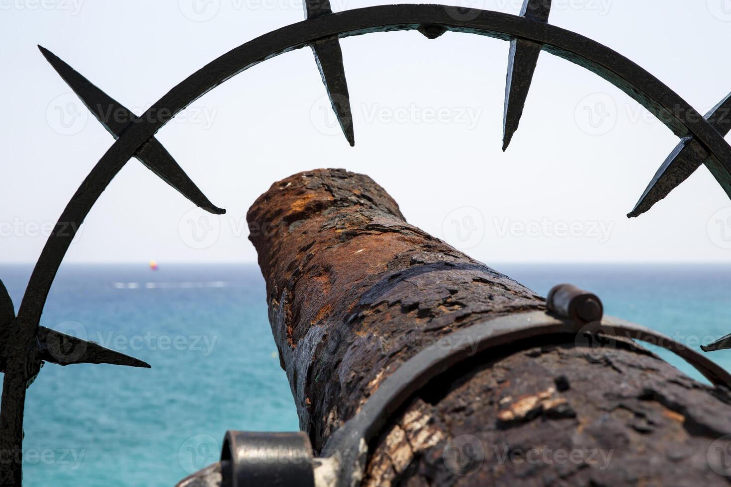 Rusty Cannon Pointed Towards the Sea on a Sunny Day, in Spain photo