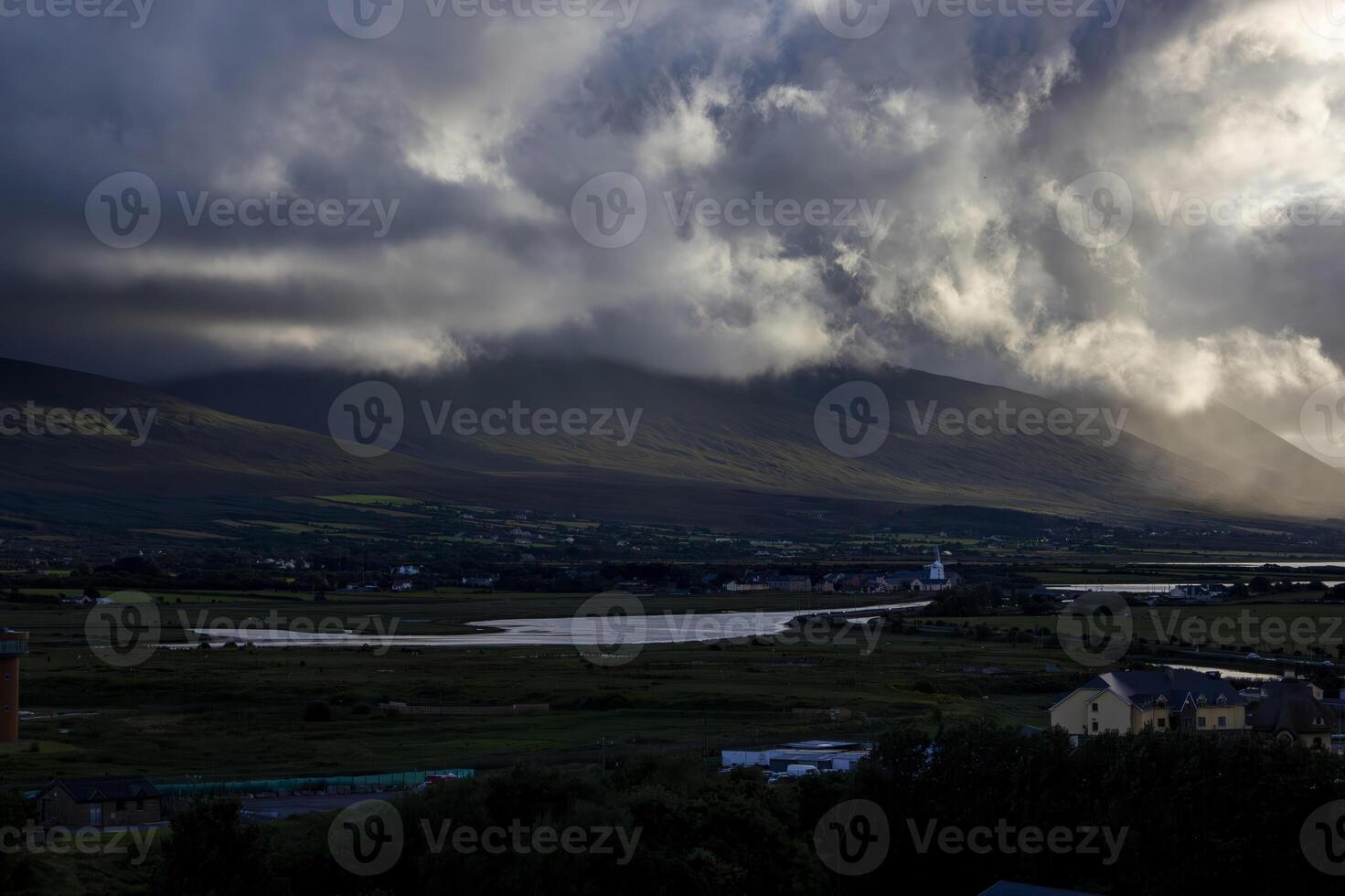 Dramatic Cloudy Sunset Over Mountains and River in Ireland photo