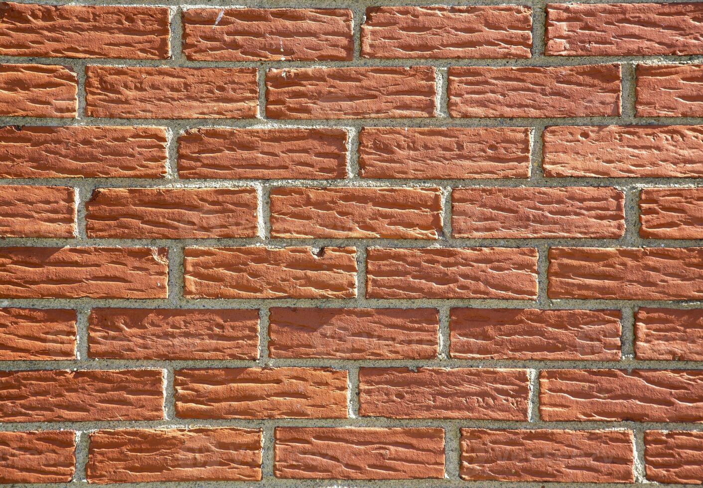Close-Up View of Red Brick Wall With Mortar photo