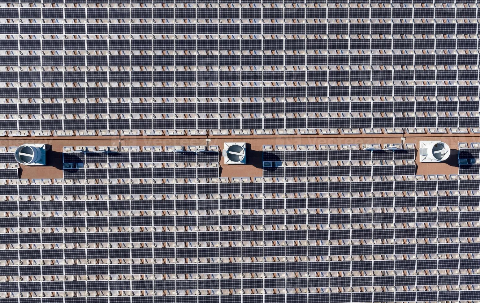 Aerial View of a Large Solar Panel Array on a Sunny Day photo