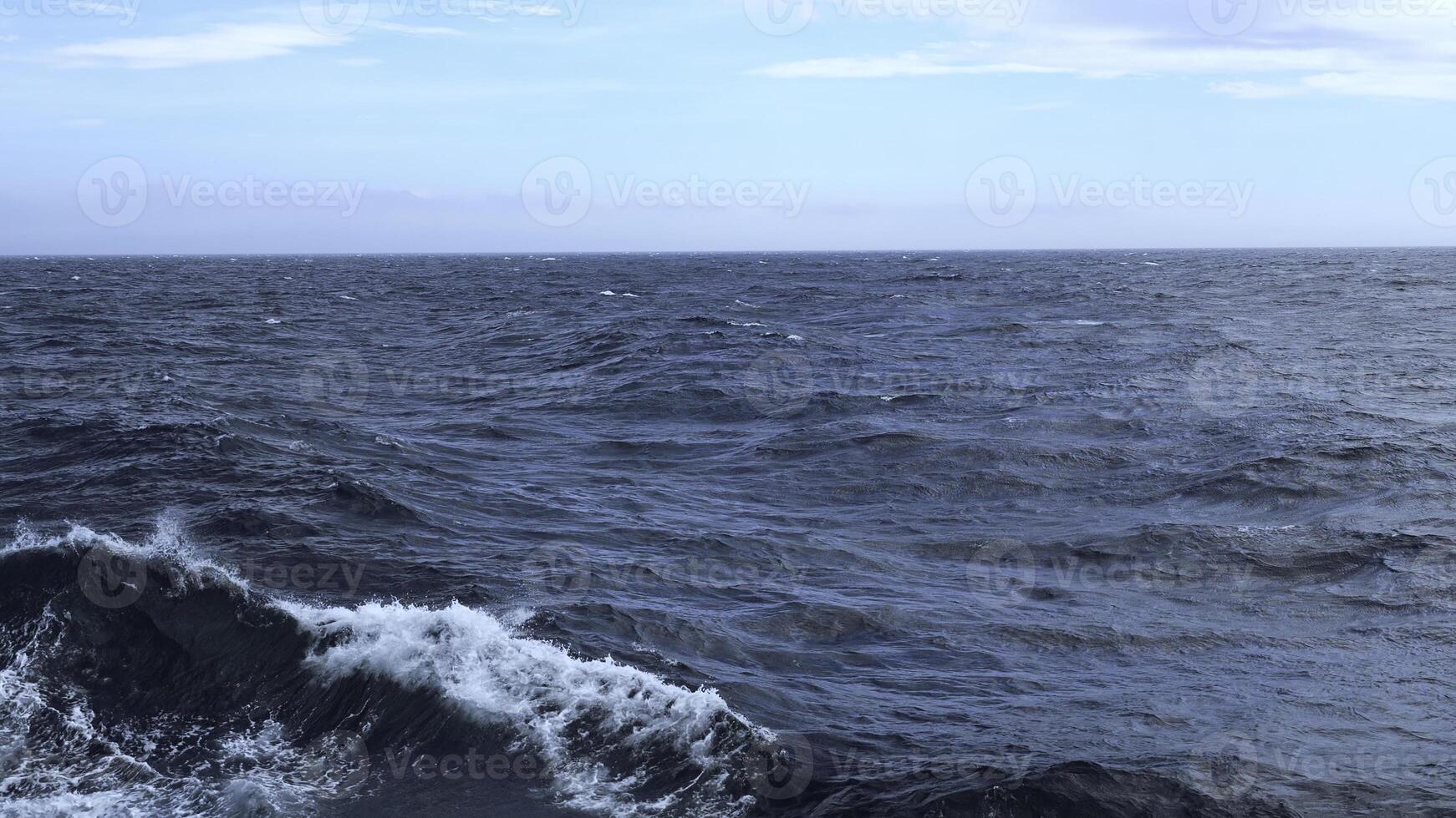 Waves from floating sea vessel. Clip. Beautiful moving waves from floating ship at sea. Beautiful sea horizon with moving waves from ship photo