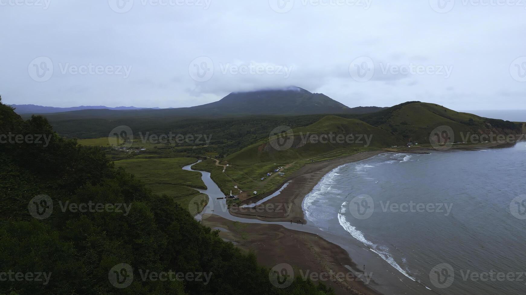 Top view of amazing landscape of mountain coast on cloudy day. Clip. Cinematic landscape of coast with rocky green mountains. Beautiful sea off coast of mountainous north island photo