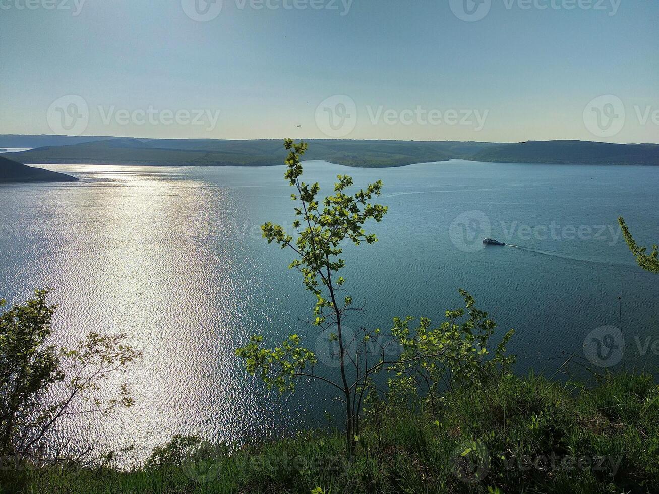 View of the sunset on the lake from the height of the mountains photo