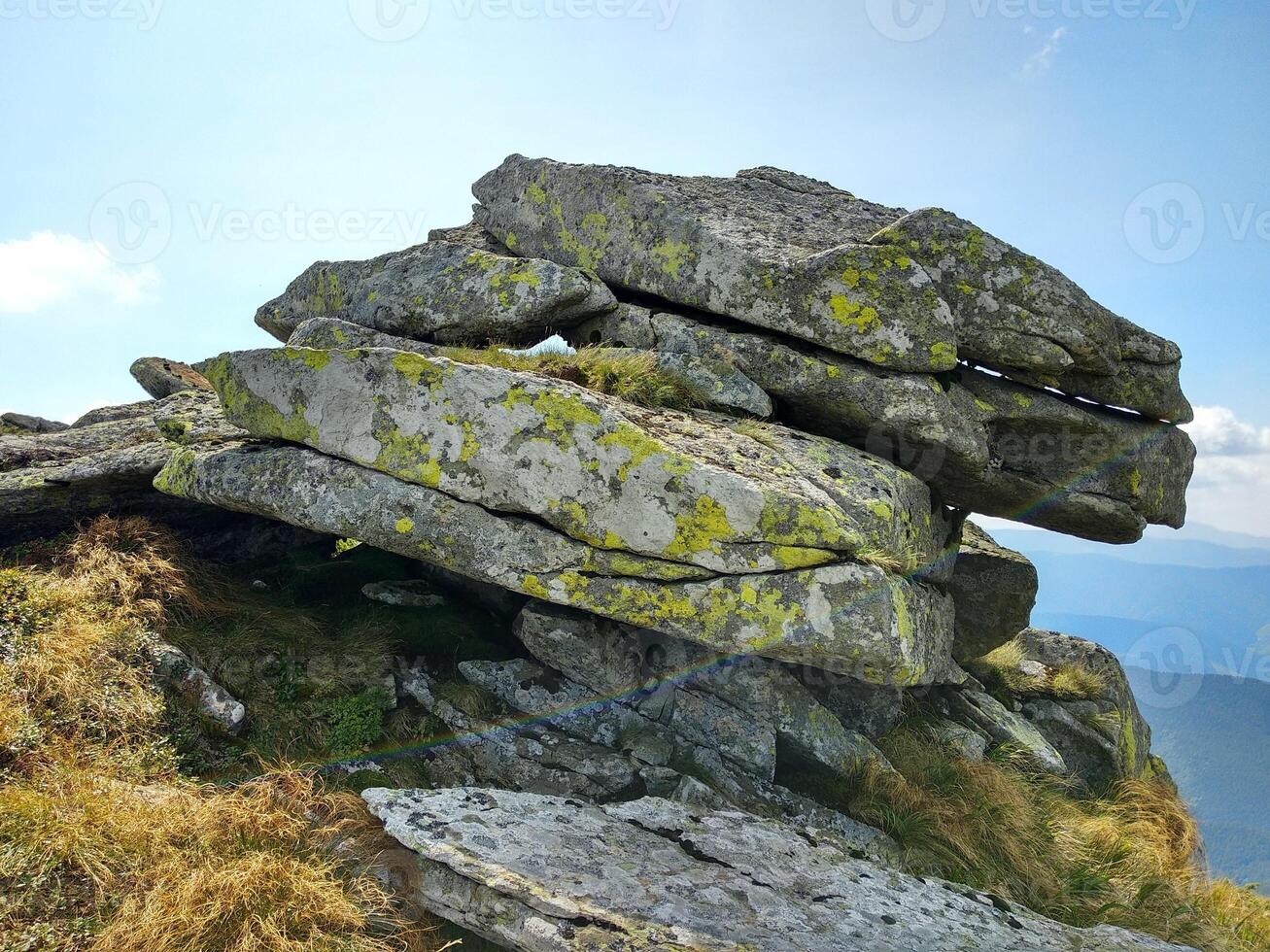 Rock formation on a tourist mountain route against the sky photo