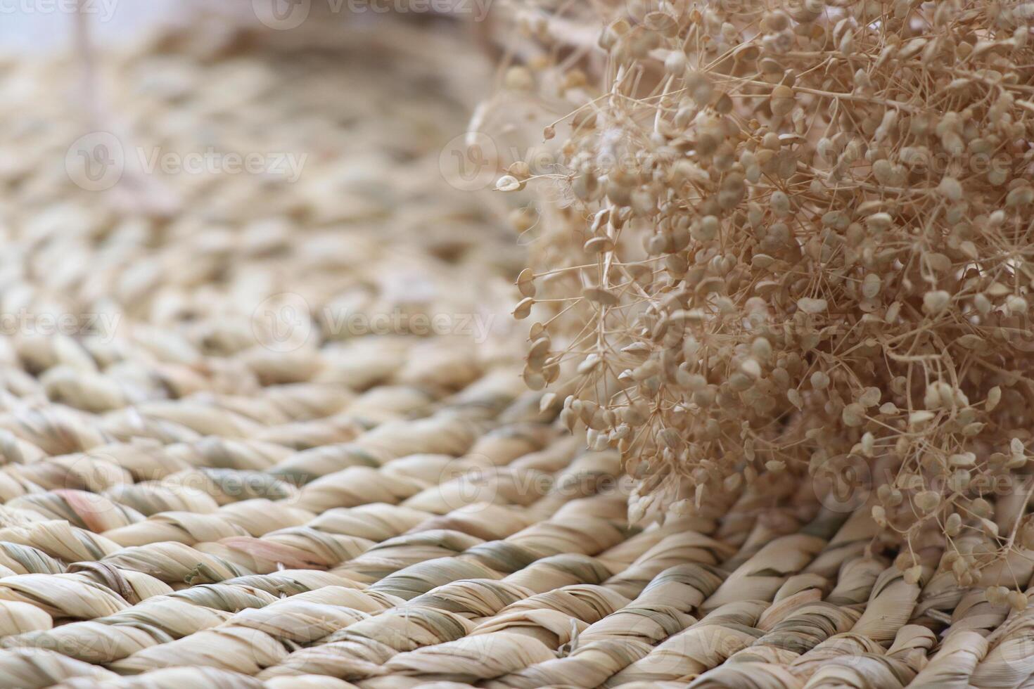 Dry flax plant and traditional painted vase on a wicker basket - Minimal decorative items photo