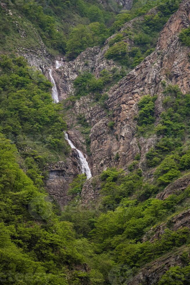 A beautiful waterfall in the heart of the mountain photo