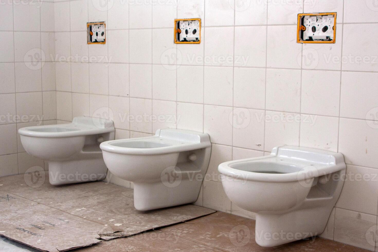 Newly installed toilets in renovated public restroom. Clean, modern design adds freshness to the space. photo