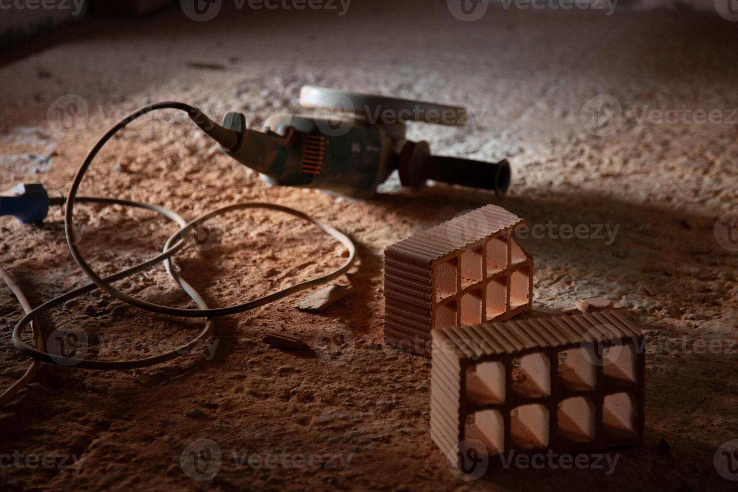 Powerful grinder next to neatly cut bricks, showcasing precision and craftsmanship. Perfect for construction and renovation themes. photo