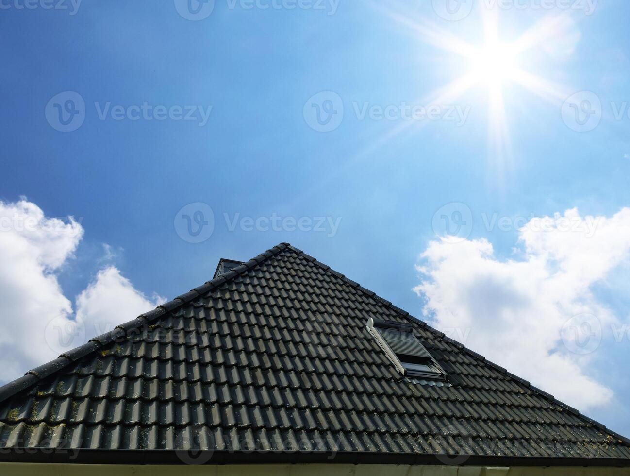 Open roof window in velux style with black roof tiles. photo