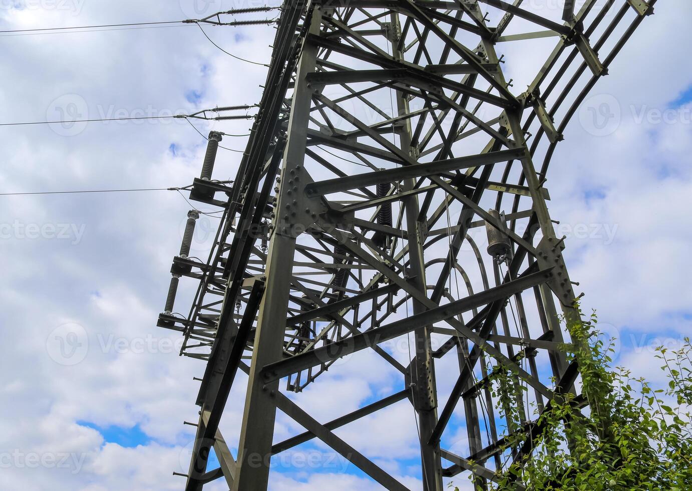 Close up view on a big power pylon transporting electricity in a countryside area photo