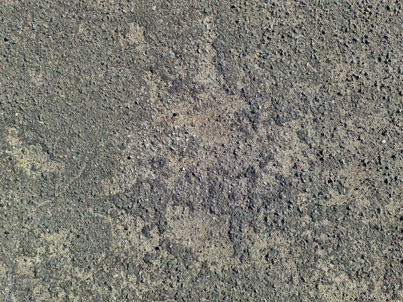 View of road asphalt with many cracks and potholes in urgent need of repair. photo