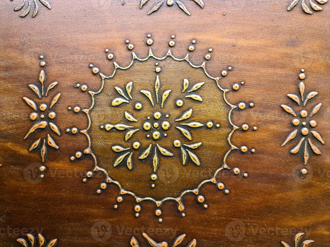An intricate oriental pattern on a beautiful wooden surface. photo