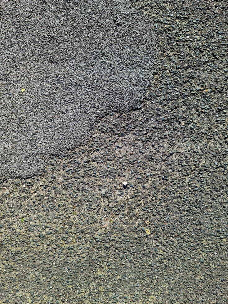 View of road asphalt with many cracks and potholes in urgent need of repair. photo