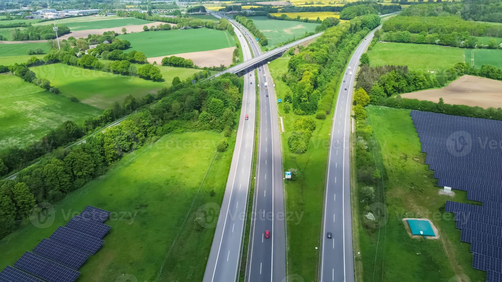 Drone view of a highway in Germany with a lot of traffic and many green fields around it. photo