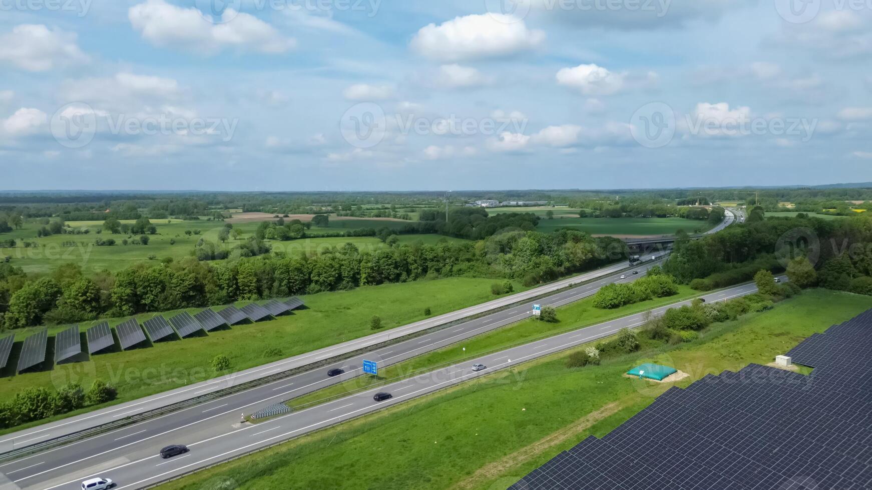 Drone view of a highway in Germany with a lot of traffic and many green fields around it. photo