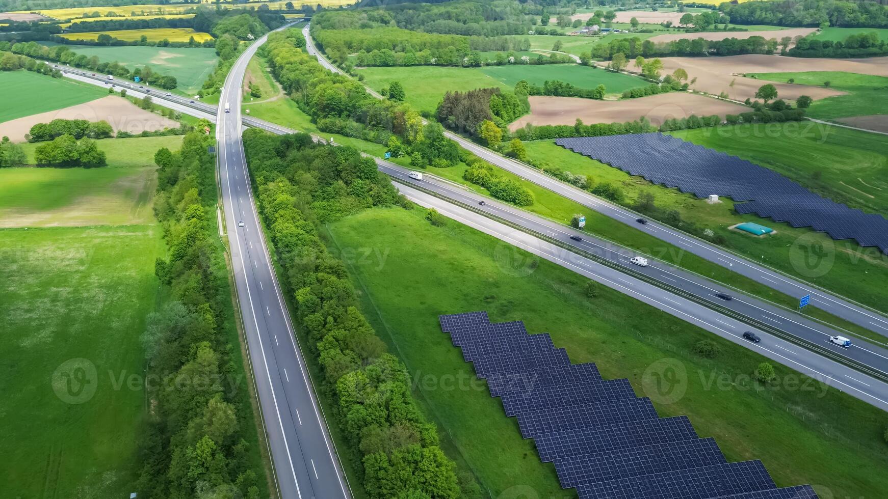 Drone view of a highway in Germany with a lot of traffic and many green fields around it. photo