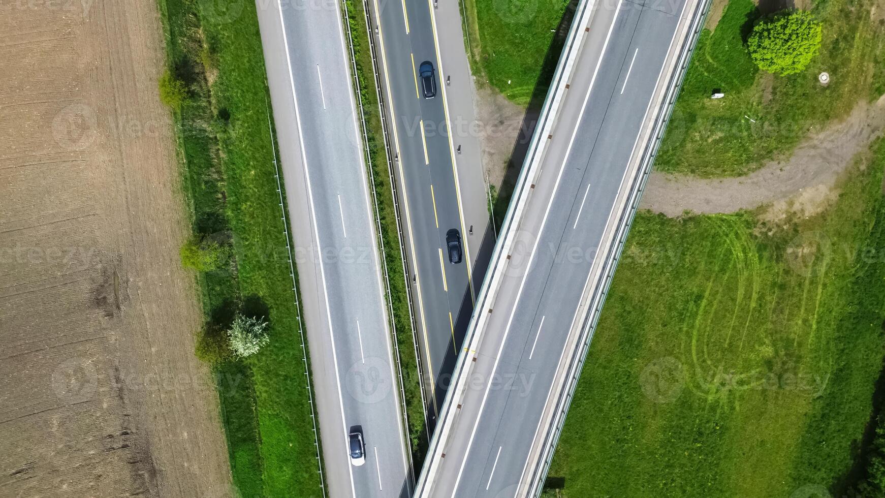Drone view of a highway in Germany with a lot of traffic and many green fields around it. photo