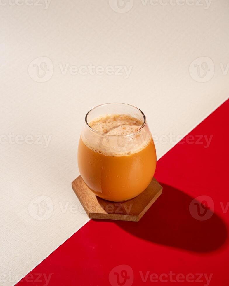 Teh Tarik is a sweet drink in the form of a mixture of tea and milk which is commonly found in Southeast Asia, especially Indonesia, Malaysia and Singapore photo