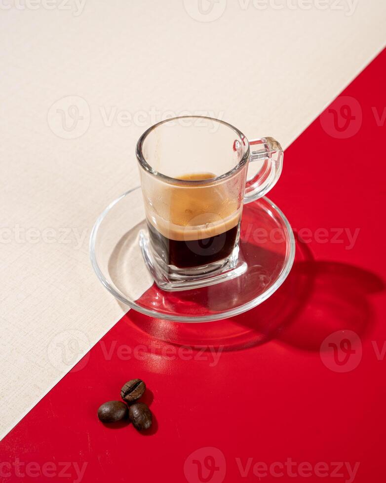 Espresso is a type of coffee produced by extracting ground coffee beans by spraying hot water under high pressure. photo